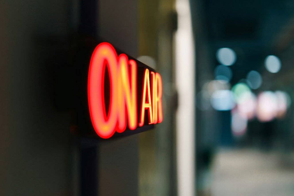 An On Air sign glowing in a radio studio