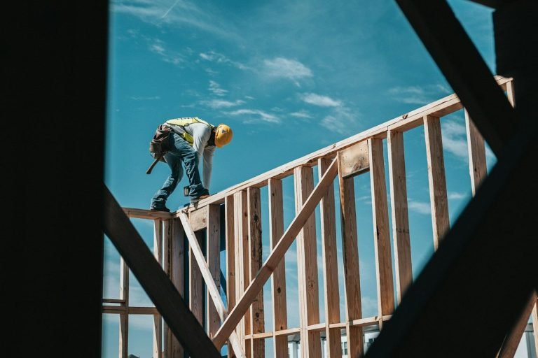 A builder on a house frame